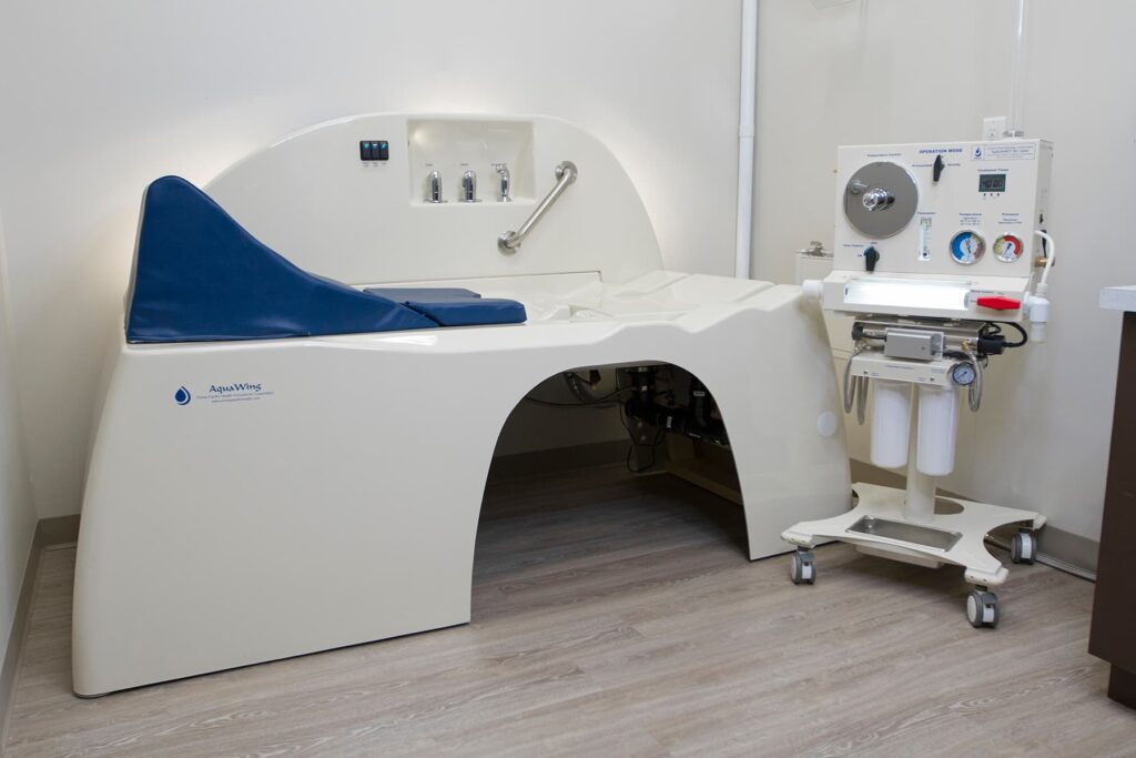 Active ventilation fan in AquaWing treatment room for colon hydrotherapy system airflow and safety.