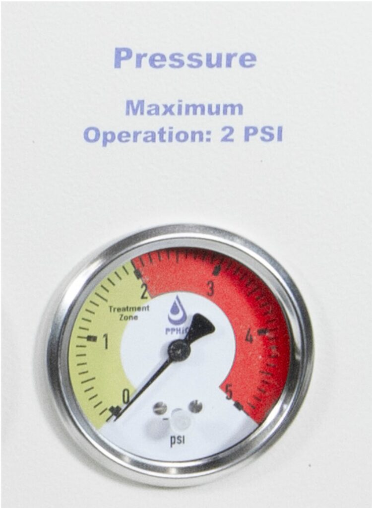 Pressure gauge on Aquanet EC-2000 colon hydrotherapy system showing maximum operation at 2 PSI