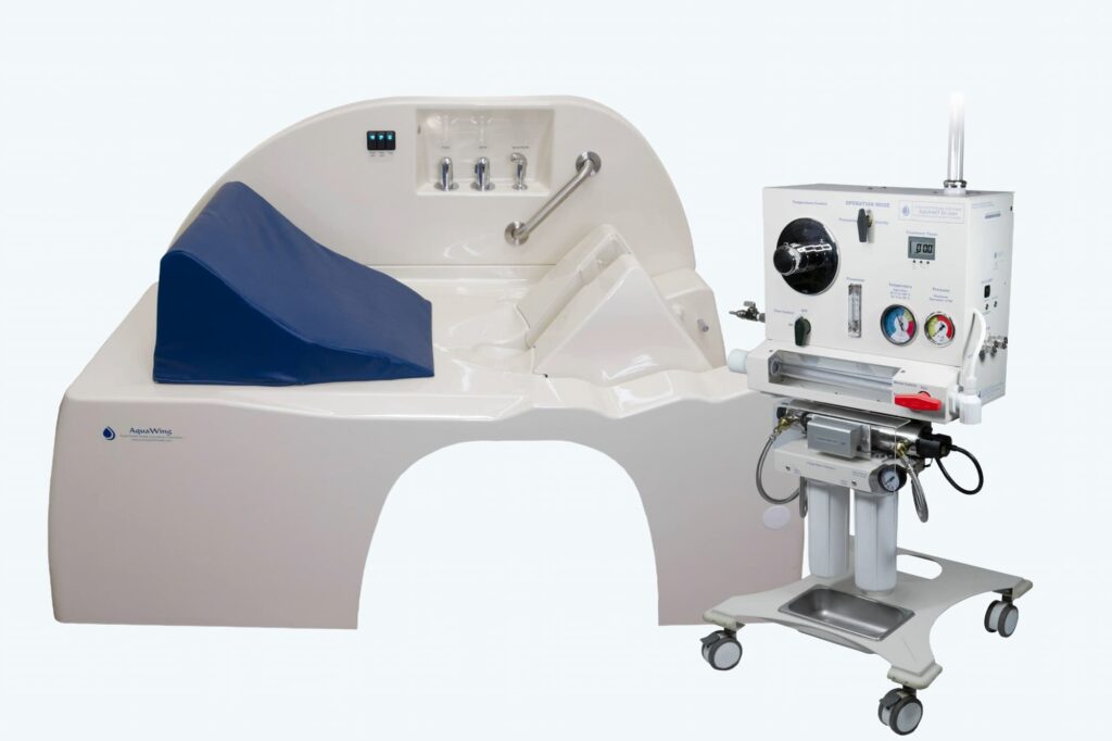 AquaWings hydrotherapy unit featuring a treatment table with a blue cushion and a mobile control panel for operations.