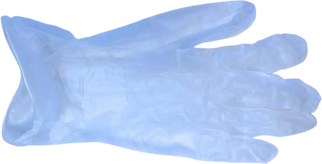 Transparent disposable glove laid flat on a surface, suitable for medical or hygienic use.