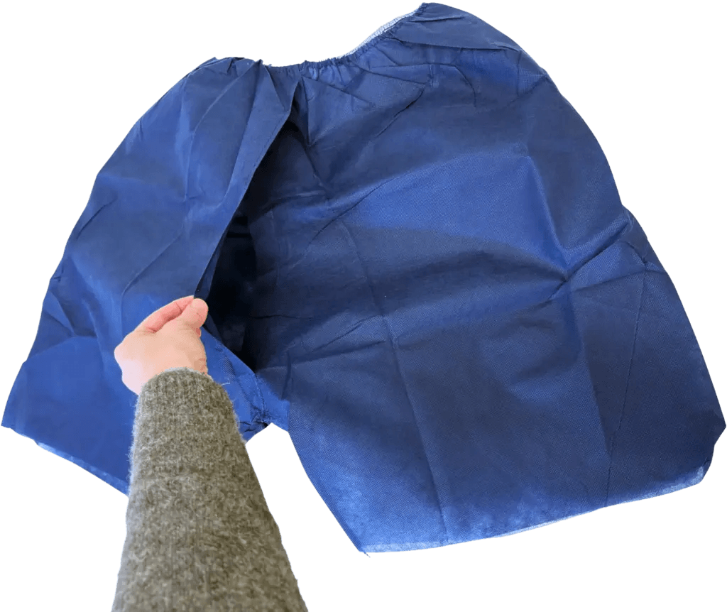 Navy blue shorts held by a hand, displaying an open section for wearing.